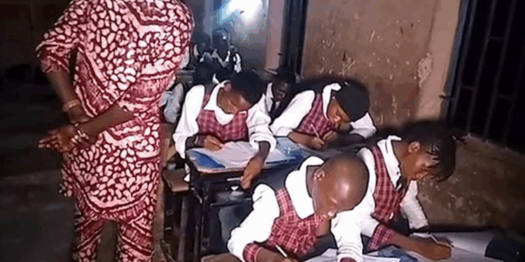 Photo of students in Taraba State writing WAEC exams late Into the night