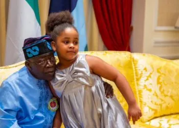 Photo President Tinubu hugging a child