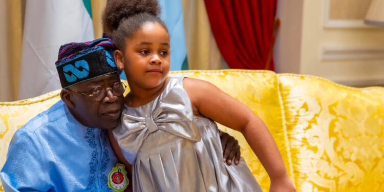 Photo President Tinubu hugging a child