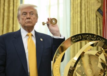 President Donald Trump holding the key to unlock the new FIFA Club World Cup trophy