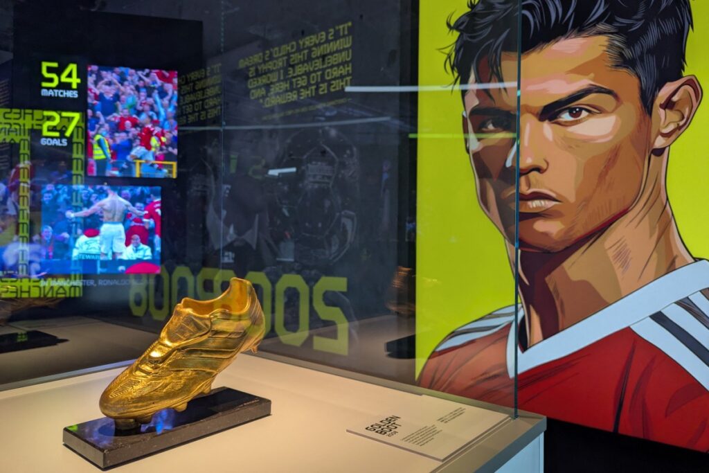Cristiano Ronaldos Golden Boot trophy is seen on display beside a portrait of the footballer during the opening of the CR7 LIFE Museum in Hong Kong