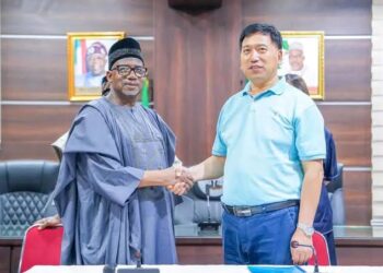 Bauchi State Governor, Bala Mohammed, shakes a Chinese national, Li Zhensheng, as Economic Adviser to the state government.