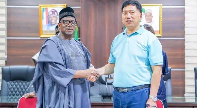 Bauchi State Governor, Bala Mohammed, shakes a Chinese national, Li Zhensheng, as Economic Adviser to the state government.