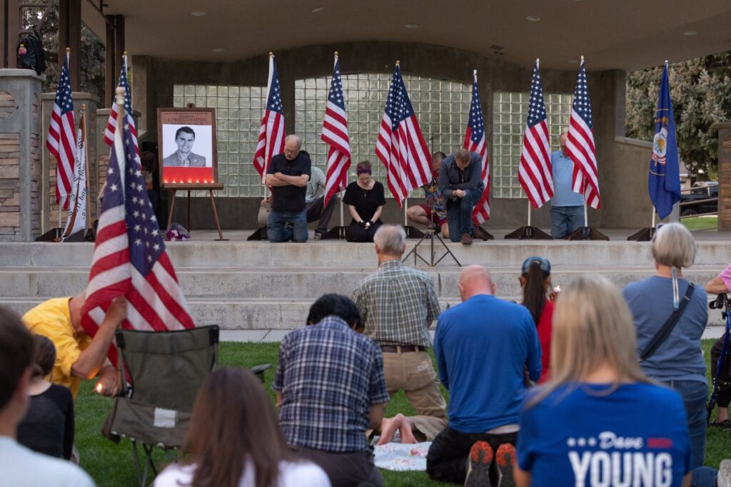 People pray as they attend a vigil for youth activist and influencer Charlie Kirk