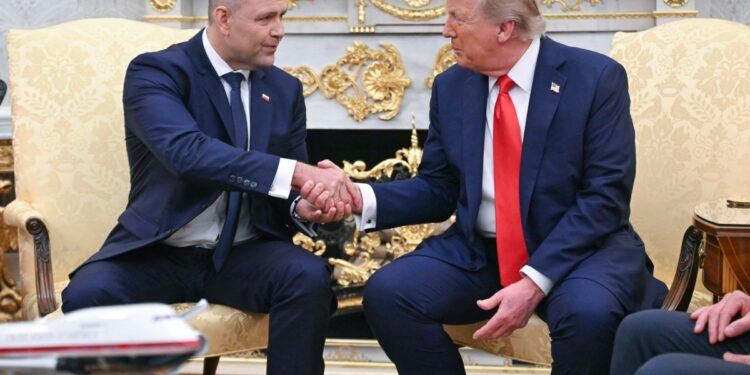 US President Donald Trump shakes hands with Polish President Karol Nawrocki.