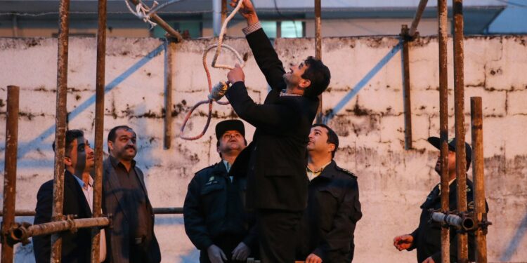 Iranian officials prepare the noose for the execution of a man.