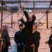 Iranian officials prepare the noose for the execution of a man.