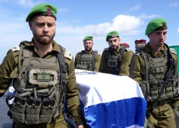 Israeli officers salute convoy as hostages' bodies return to Israel