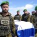 Israeli officers salute convoy as hostages' bodies return to Israel