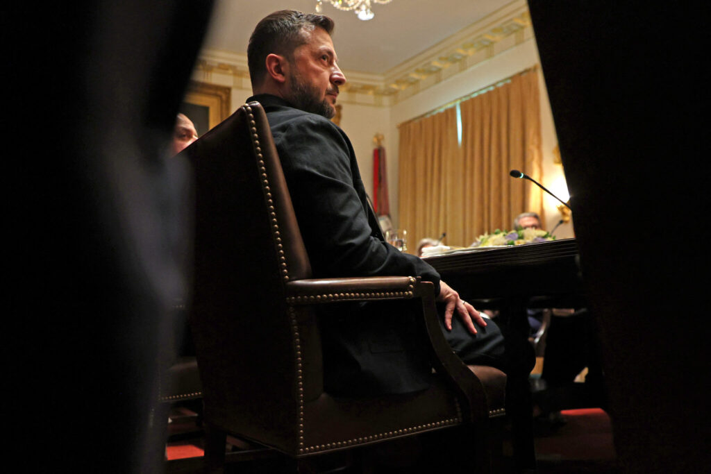 Ukrainian President Volodymyr Zelensky meets with unseen US President Donald Trump in the Cabinet Room of the White House.
