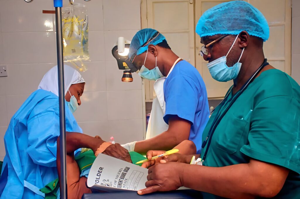 Doctors operating on a patient during the medical outreach.