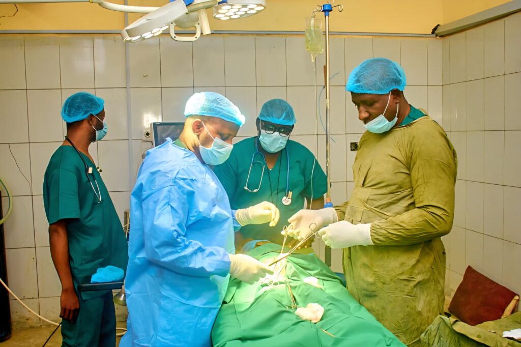 Doctors operating on a patient during the medical outreach.