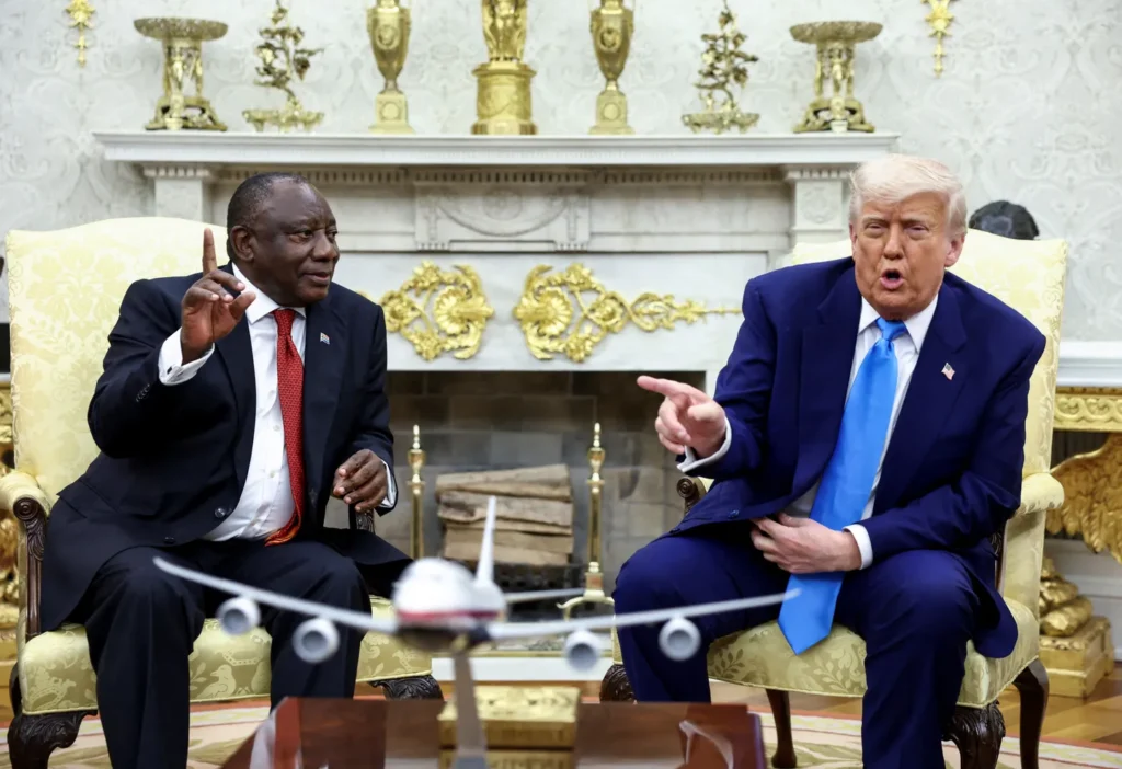  US President Donald Trump shows pictures and articles as he meets with South African President Cyril Ramaphosa.