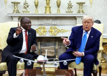 US President Donald Trump shows pictures and articles as he meets with South African President Cyril Ramaphosa.