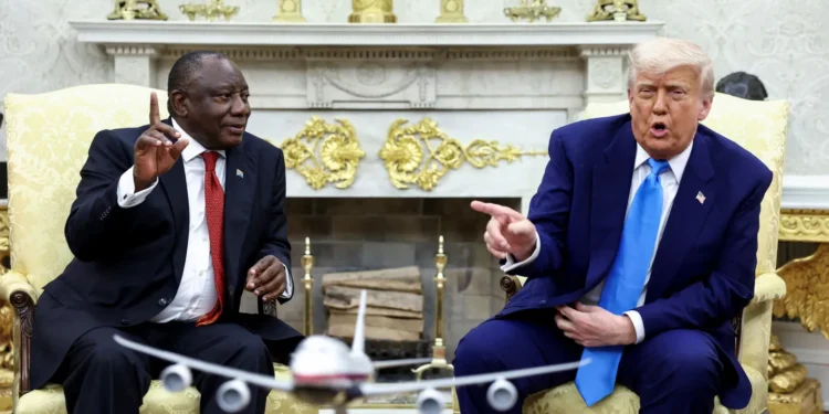 US President Donald Trump shows pictures and articles as he meets with South African President Cyril Ramaphosa.