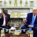 US President Donald Trump shows pictures and articles as he meets with South African President Cyril Ramaphosa.