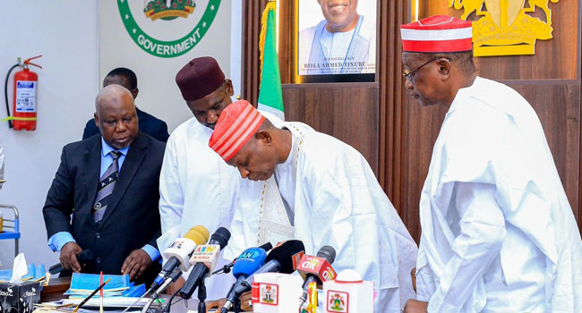 Governor Abba Kabir Yusuf signing the Kano State Security Neighborhood Watch Law.