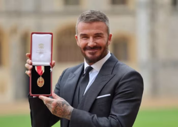 Former England footballer David Beckham poses with their medal after being appointed as a Knight Bachelor (Knighthood) for services to sport and charity at an investiture ceremony at Windsor Castle.