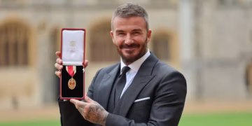 Former England footballer David Beckham poses with their medal after being appointed as a Knight Bachelor (Knighthood) for services to sport and charity at an investiture ceremony at Windsor Castle.