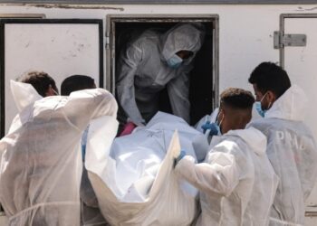 Employees of the Nasser Medical Complex unload one of the thirty bodies of Palestinian prisoners detained by Israel and released as part of the hostage exchange deal, as the body bags arrive in Khan Yunis, in the southern Gaza Strip, on October 31, 2025.