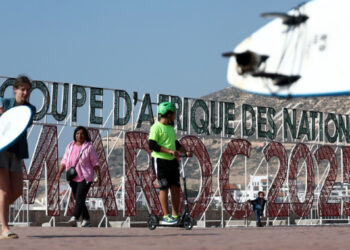 People walk along the corniche promenade in Agadir, Morocco.