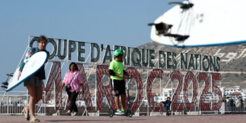 People walk along the corniche promenade in Agadir, Morocco.