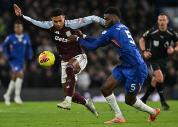Aston Villa's English striker, Ollie Watkins (L) clashes with Chelsea's French defender, Benoit Badiashile, during the English Premier League football match between Chelsea and Aston Villa at Stamford Bridge.