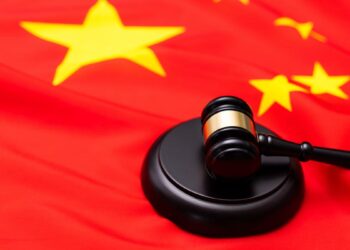 Photo of Chinnese flag and a gavel