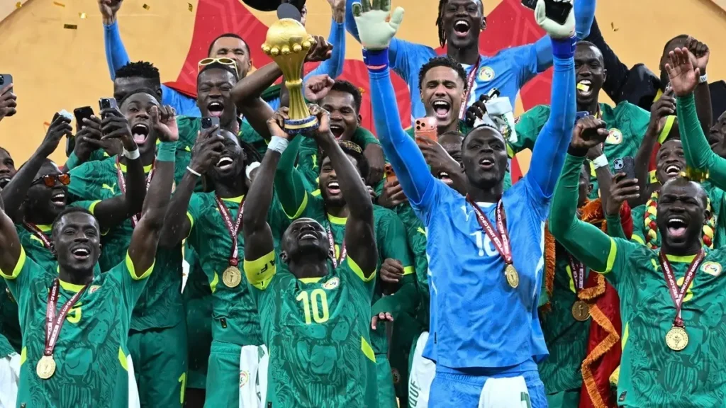 Senegal players celebrating after beating Morocco 1-0 to win the Africa Cup of Nations final match