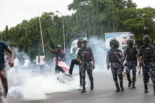 Policemen teargas protesters