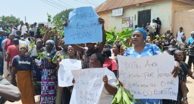 Women and youths staged a protest outside the church, demanding the release of the three youths earlier arrested by the military.
